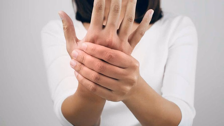 Bác sĩ thăm khám lâm sàng tầm vận động khớp ngón tay cho người bệnh